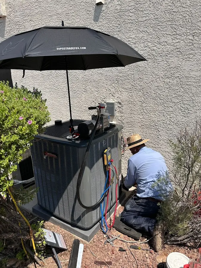 HVAC technician performing outdoor AC maintenance in Montvale